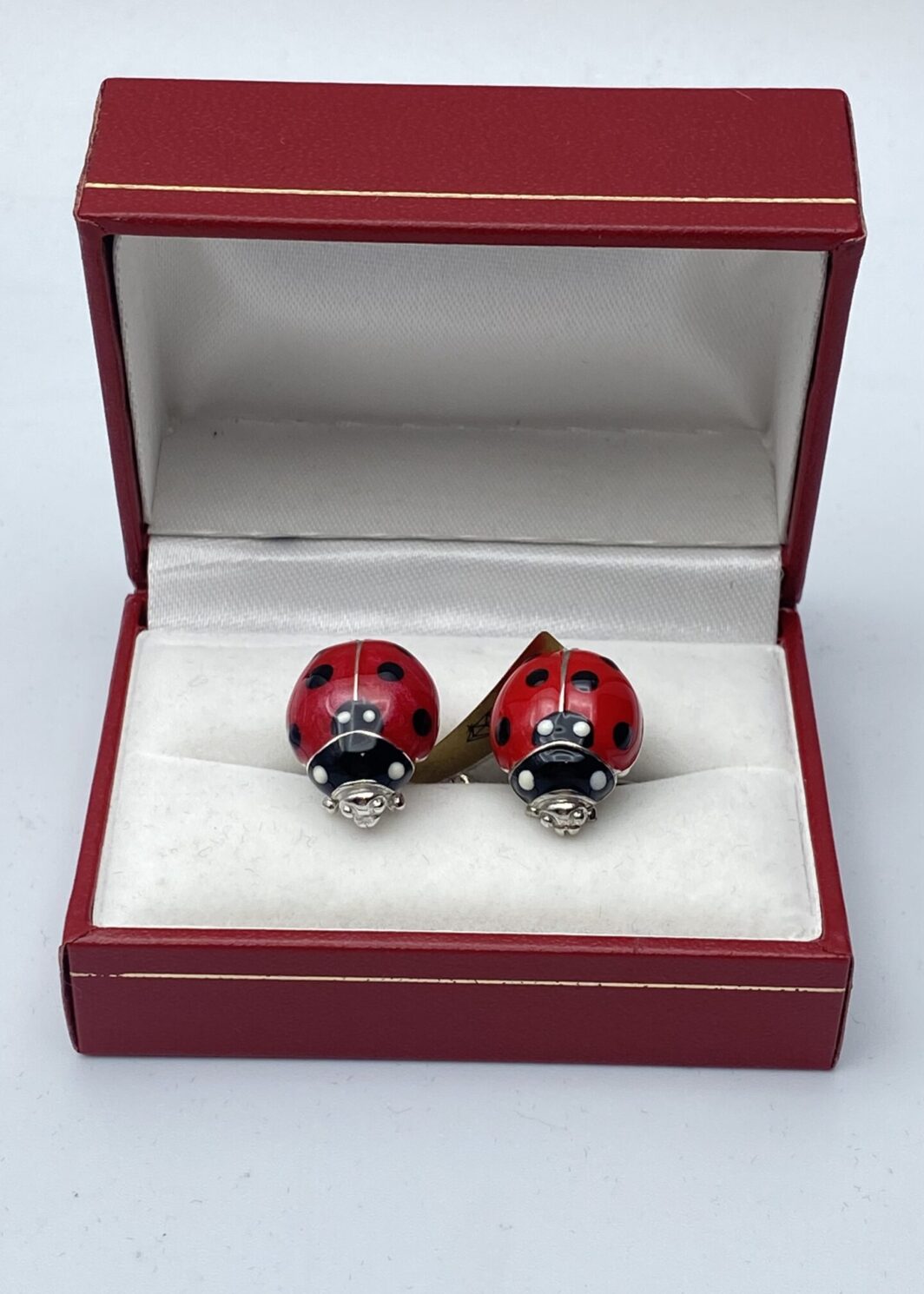 PAIO DI GEMELLI IN ARGENTO E SMALTI CON COCCINELLE.