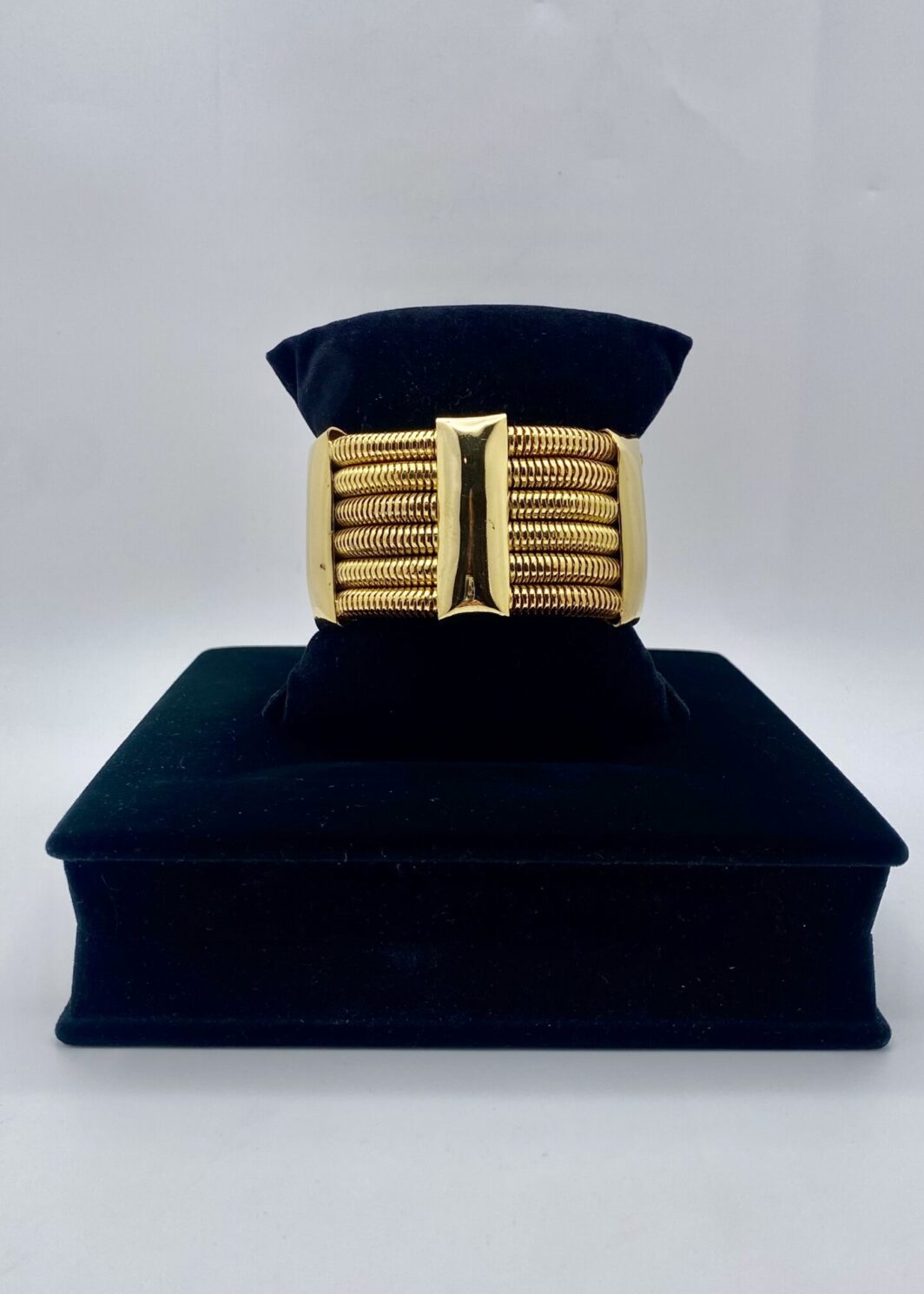 “GENNY” VINTAGE. BRACCIALE SEMIRIGIDO A POLSIERA IN METALLO GOLDTONE.
