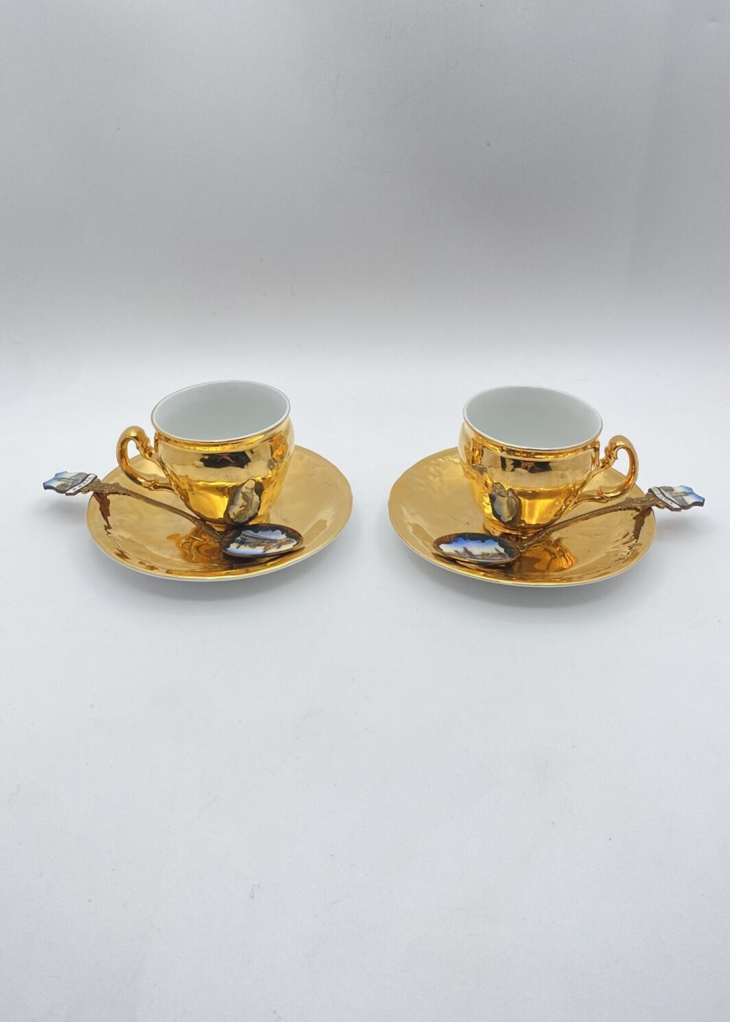 TÊTE-À-TÊTES DI TAZZINE IN PORCELLANA DORATA, CON CUCCHIAINI SMALTATI ORIGINALI. SOUVENIR VINTAGE ANNI ‘50 ca. PRAGA