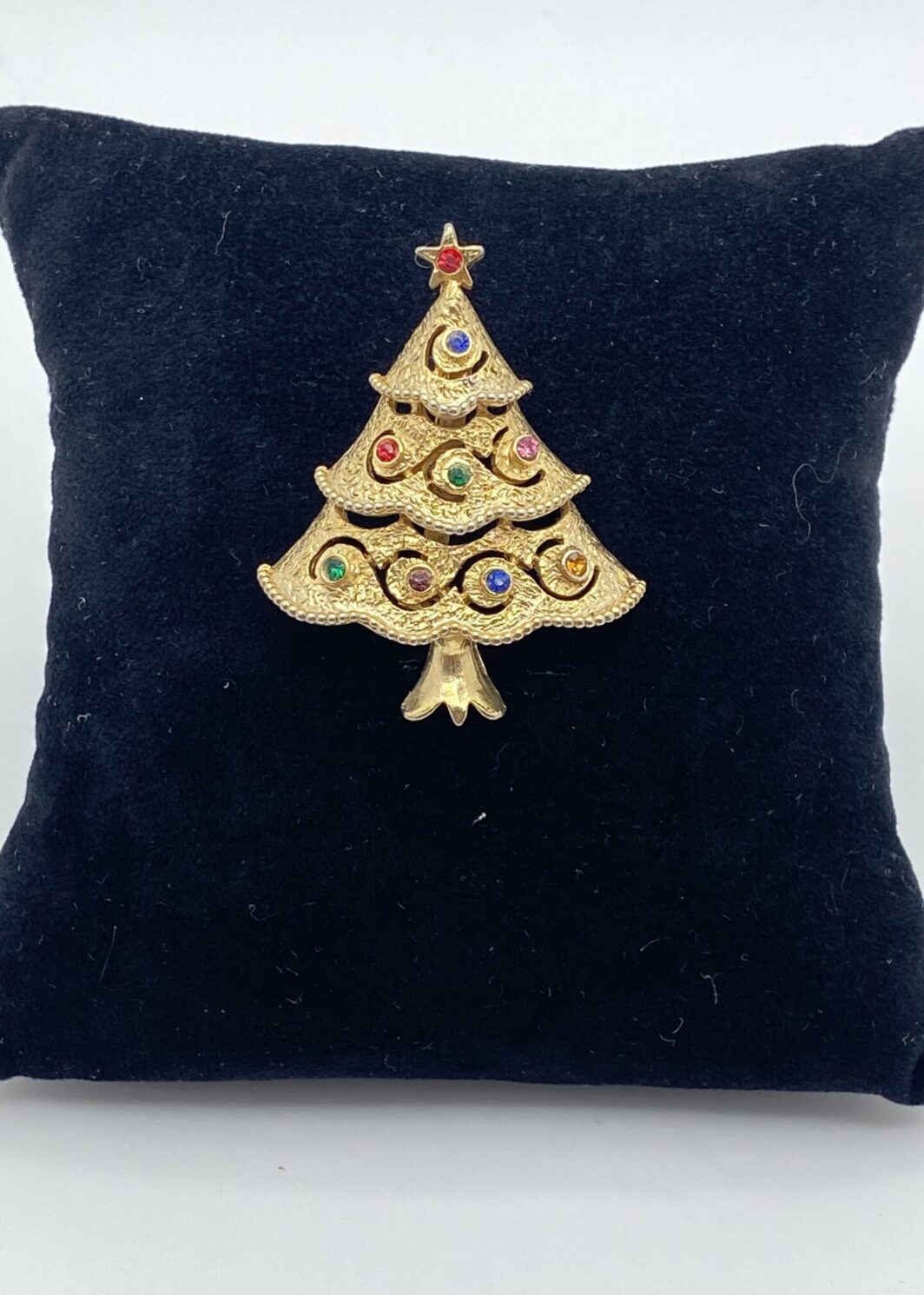 “J.J.” SPILLA VINAGE ANNI ‘50 A FORMA DI ALBERO DI NATALE, IN METALLO GOLDTONE E CRISTALLI POLICROMI. U.S.A.